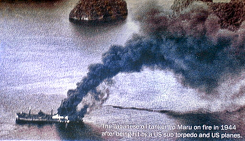 Amatzu Maru hit by a bomb and burning, old photo from world war 2 