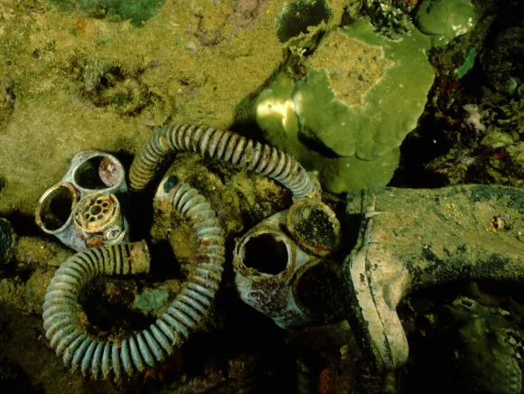 underwater photo of gas masks and rubber boots in a wreck in Palau