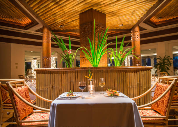 Ribtal restaurant at Palau Pacific resort, table with 2 chairs with food and wine
