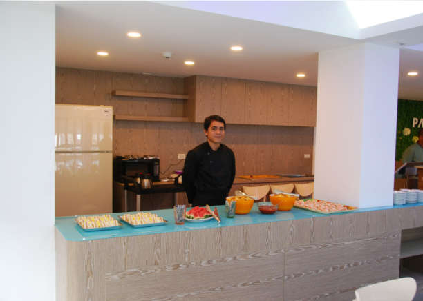 Palau Hotel a waiter behind the bar offering breakfast
