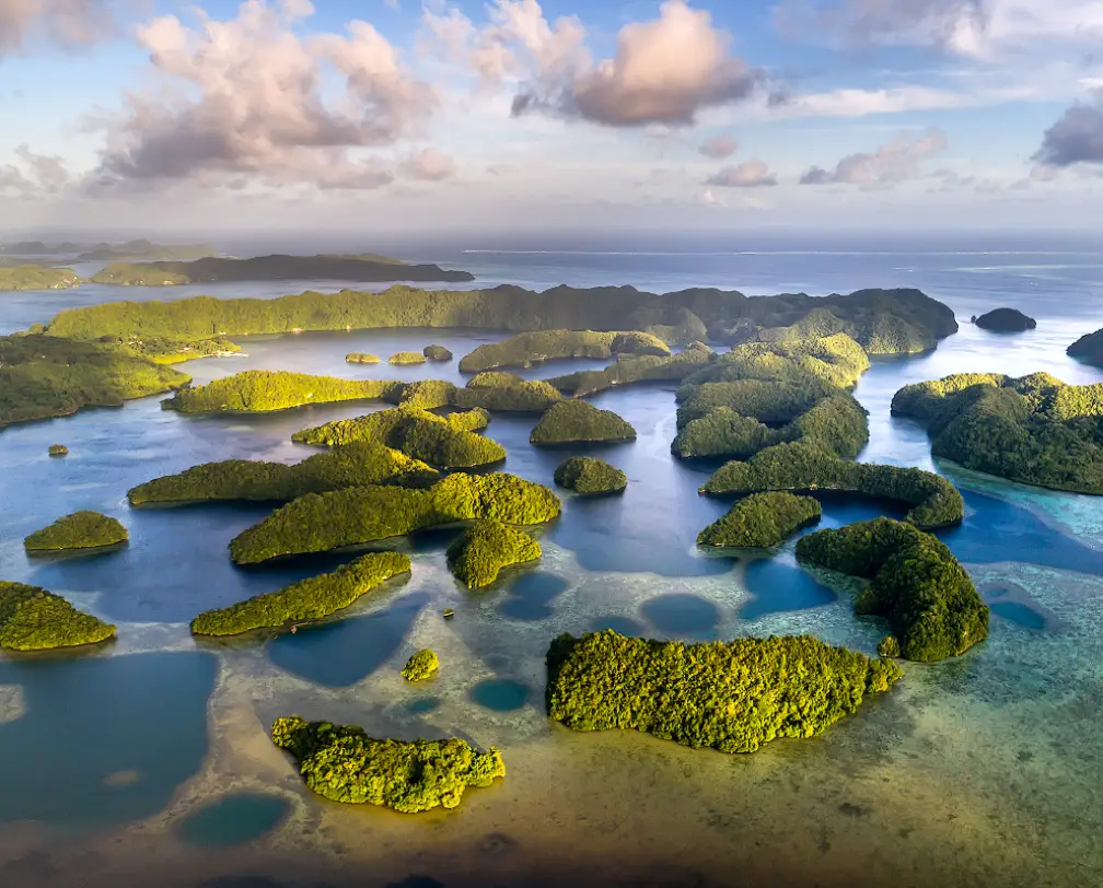 aerial photo of the Rock Islands in Palau, with ocean and Rock islands in a golden light