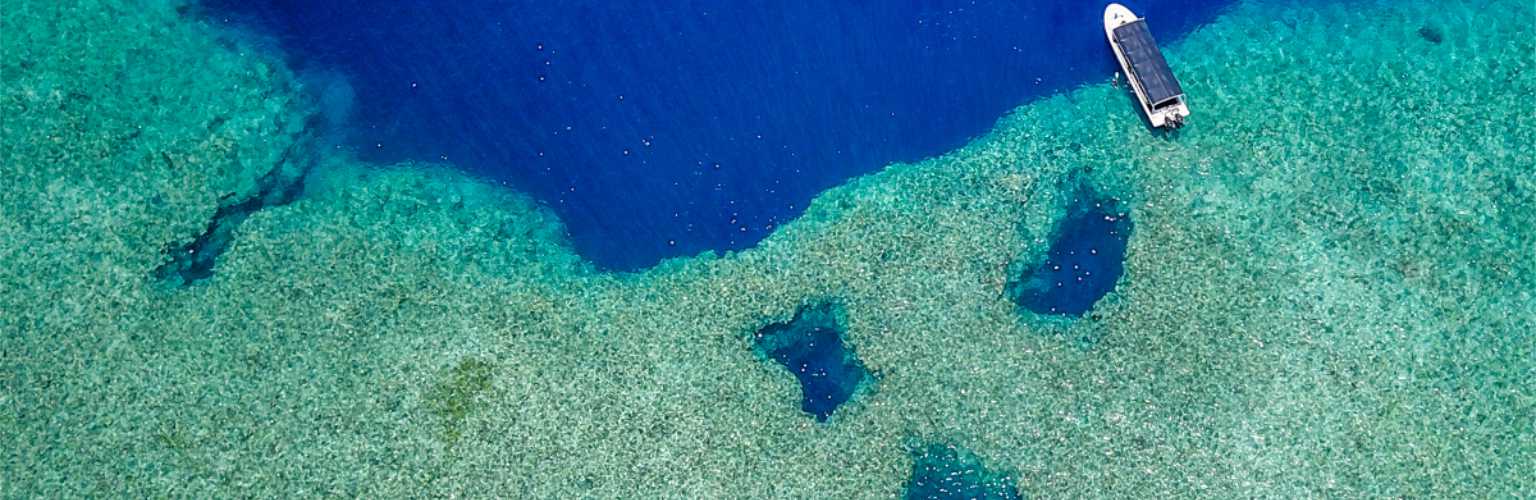 Aerial photo of a dive boat at the reef at Blue holes in Palau